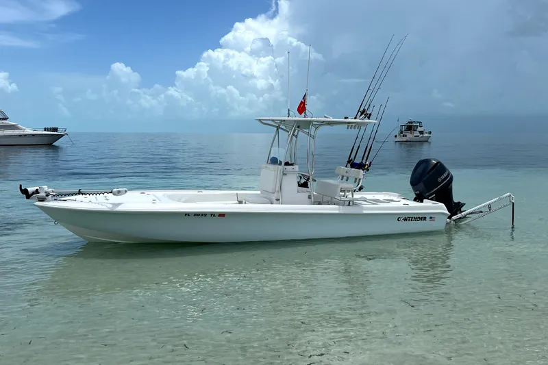 The Image of 2018 Contender 25 Bay boat anchored in shallow, clear water with fishing rods. - 0