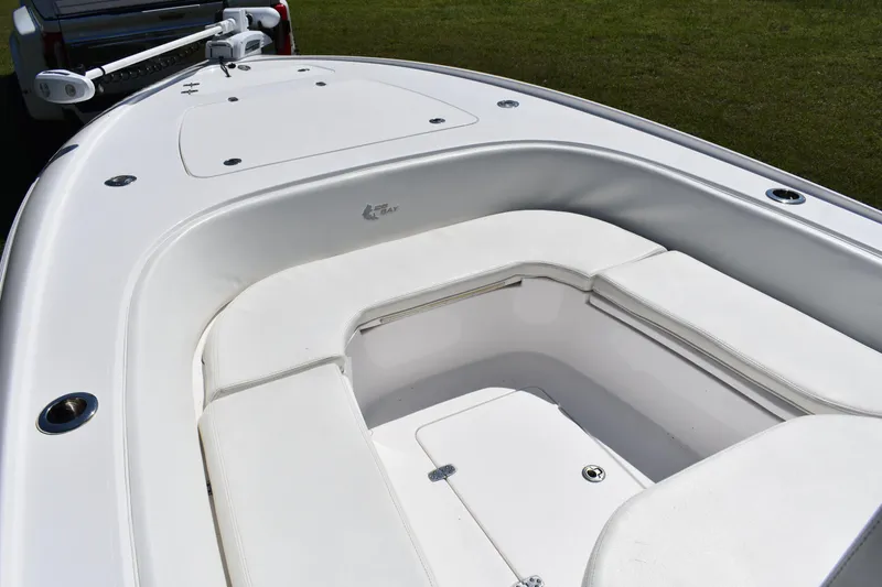 Slide: The Image of 2018 Contender 25 Bay boat interior with white seating and storage compartments. - 11