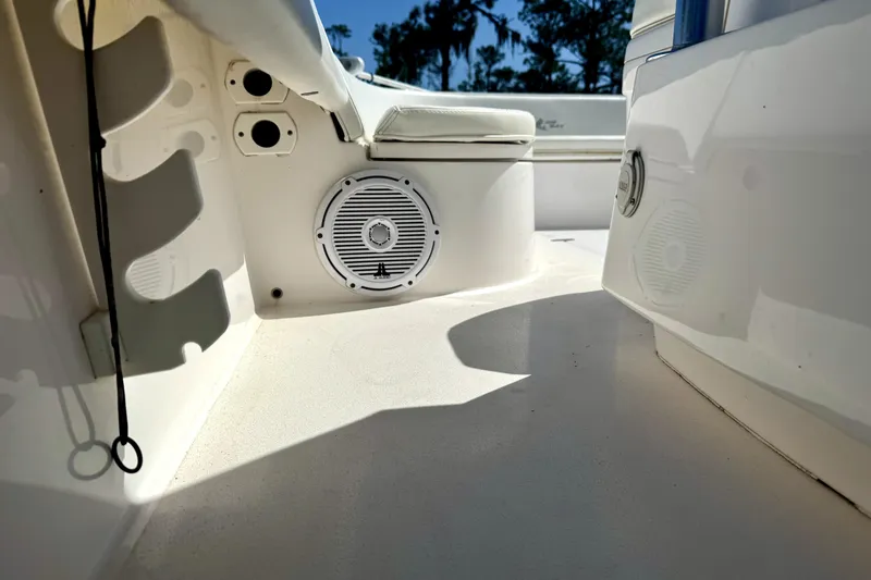 Slide: The Image of 2018 Contender 25 Bay boat interior with speaker and seating area. - 18