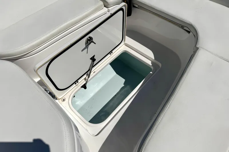 Slide: The Image of Open storage compartment on 2018 Contender 25 Bay boat, featuring white cushioned seating. - 20