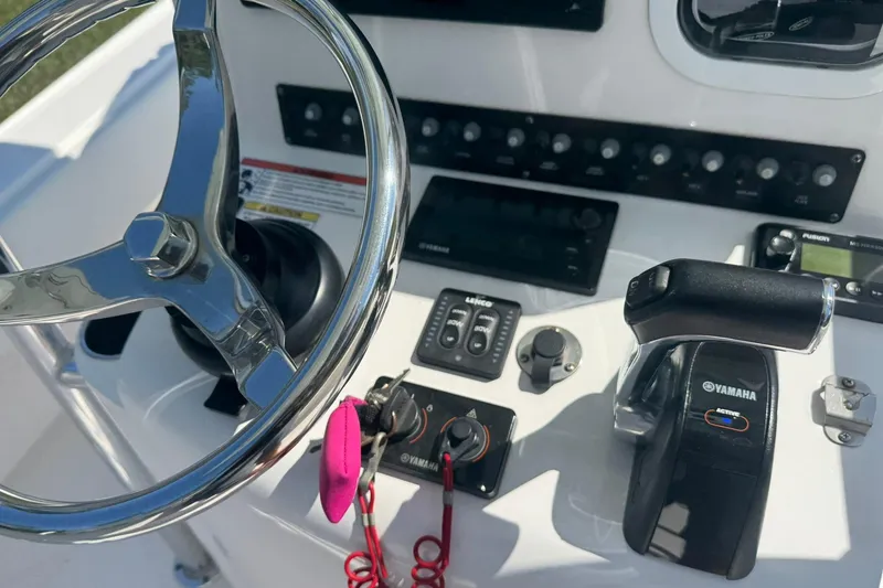 Slide: The Image of 2018 Contender 25 Bay boat dashboard with steering wheel and Yamaha controls. - 24