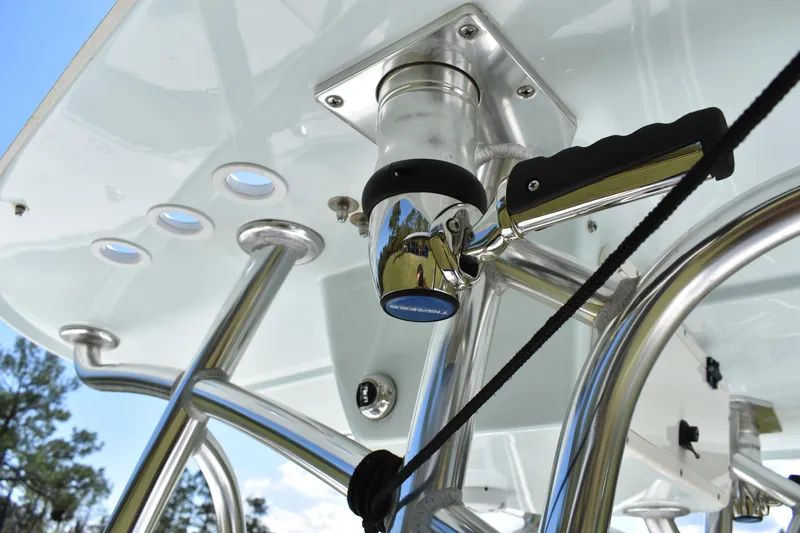 Slide: The Image of 2018 Contender 25 Bay boat T-top with stainless steel rod holders and handle. - 29