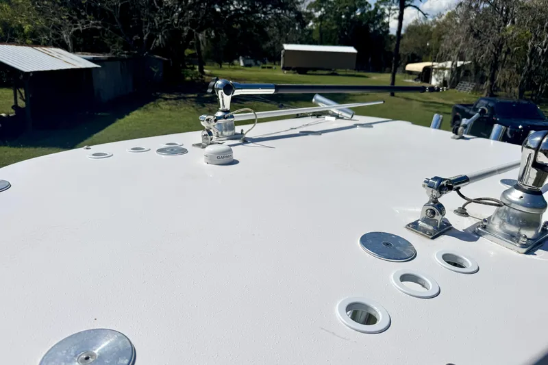 Slide: The Image of 2018 Contender 25 Bay boat deck with fishing rod holders and Garmin equipment. - 31