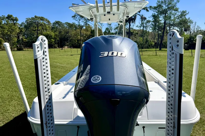 Slide: The Image of 2018 Contender 25 Bay boat with Yamaha 300 engine, displayed outdoors. - 7