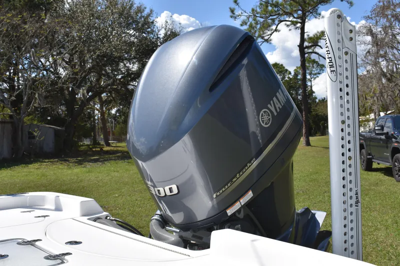 Slide: The Image of 2018 Contender 25 Bay with Yamaha outboard motor and Power-Pole, parked on grass. - 8