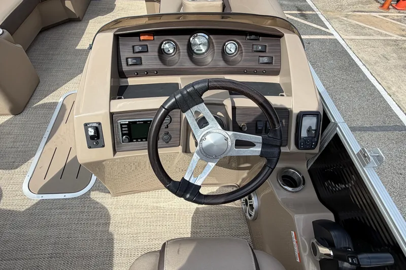 Slide: The Image of 2019 Bennington 23 SX Entertainment boat dashboard with steering wheel and controls. - 12