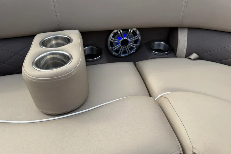 Slide: The Image of 2019 Bennington 23 SX Entertainment boat interior with cup holders and speaker. - 14