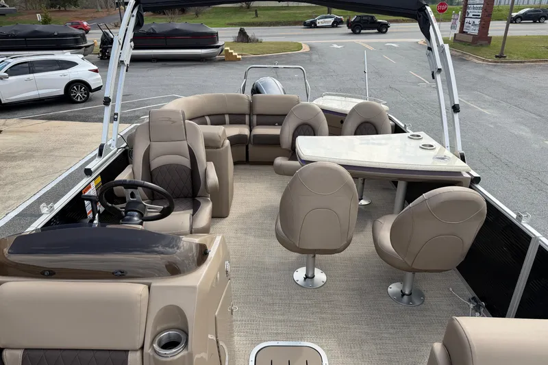 Slide: The Image of 2019 Bennington 23 SX Entertainment pontoon boat with spacious seating and table setup. - 15