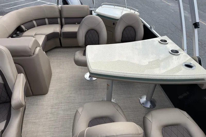 Slide: The Image of 2019 Bennington 23 SX Entertainment boat interior with plush seating and sleek table design. - 16