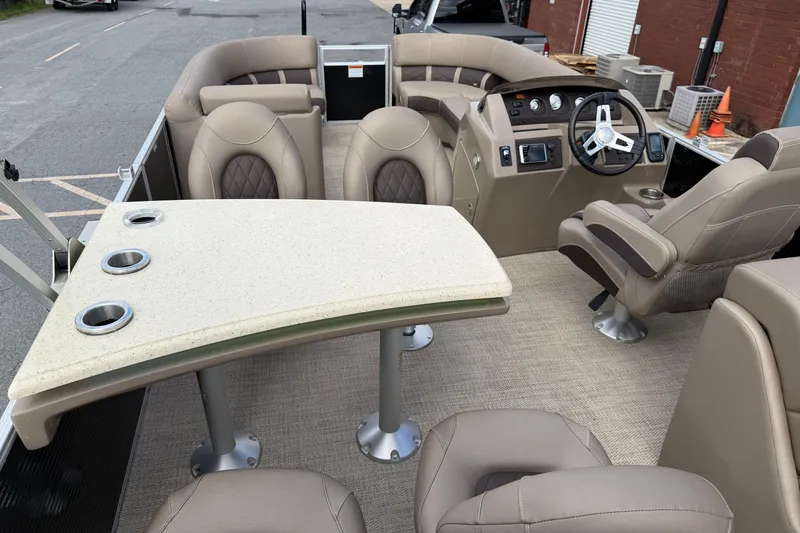 Slide: The Image of 2019 Bennington 23 SX Entertainment boat interior with plush seating and steering console. - 17