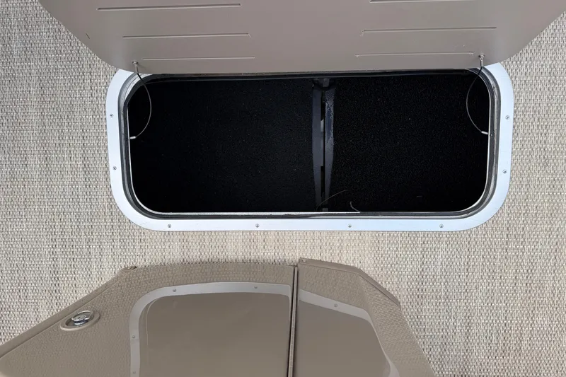 Slide: The Image of Open storage compartment on 2019 Bennington 23 SX Entertainment boat, beige interior. - 18