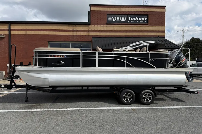 Slide: The Image of 2019 Bennington 23 SX Entertainment pontoon boat on trailer, parked outside Yamaha Indmar building. - 4