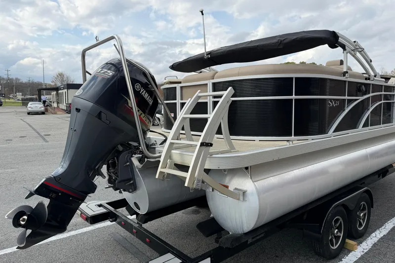 Slide: The Image of 2019 Bennington 23 SX Entertainment pontoon boat with Yamaha 175 engine on trailer. - 7