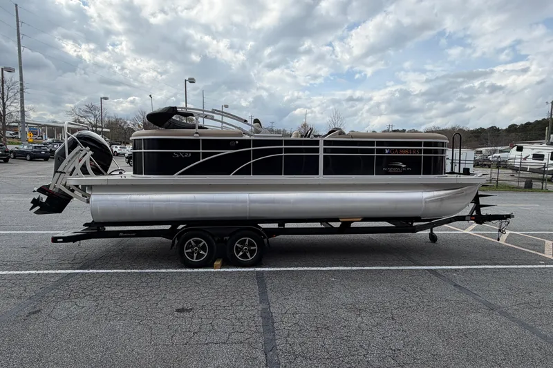 Slide: The Image of 2019 Bennington 23 SX Entertainment pontoon boat on trailer in parking lot. - 8