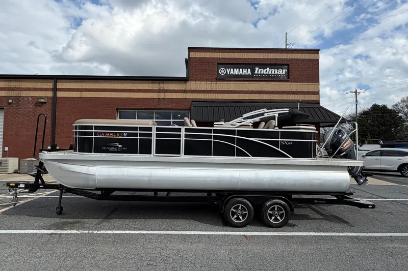 Slide: The Image of 2019 Bennington 23 SX Entertainment pontoon boat on trailer, parked outside Yamaha Indmar building. - 9