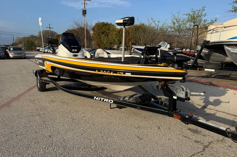 The Image of 2015 Nitro Z-6 boat on trailer in parking lot, sunny day. - 1