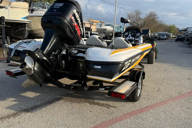 Slide: The Image of 2015 Nitro Z-6 boat with Mercury 115 Pro XS engine, parked outdoors. - 10