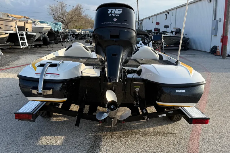Slide: The Image of 2015 Nitro Z-6 boat with 115 Pro outboard motor, parked in a marina. - 11