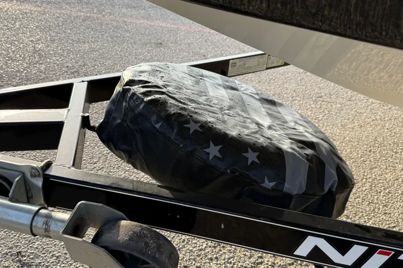 Slide: The Image of Trailer hitch with American flag cover on a 2015 Nitro Z-6 boat trailer. - 15