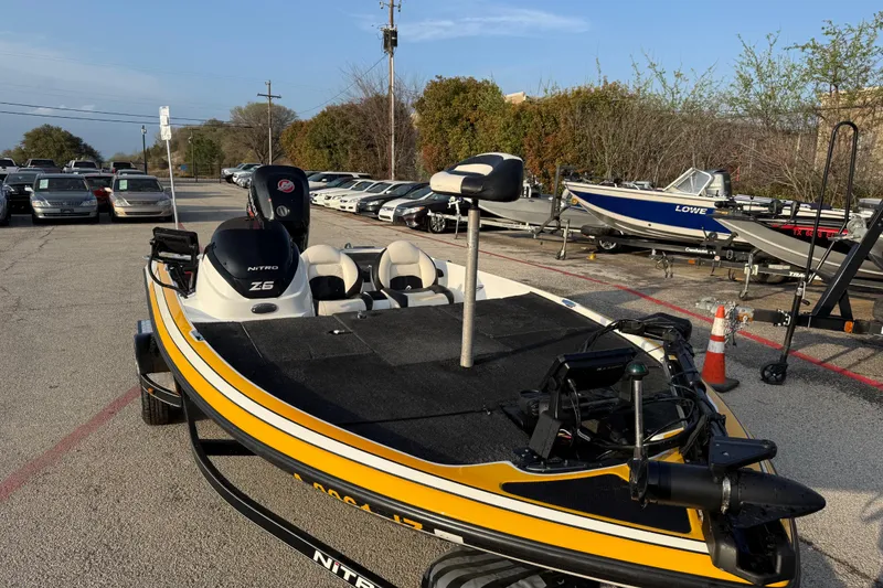 Slide: The Image of 2015 Nitro Z-6 boat in parking lot, surrounded by cars and trees. - 21