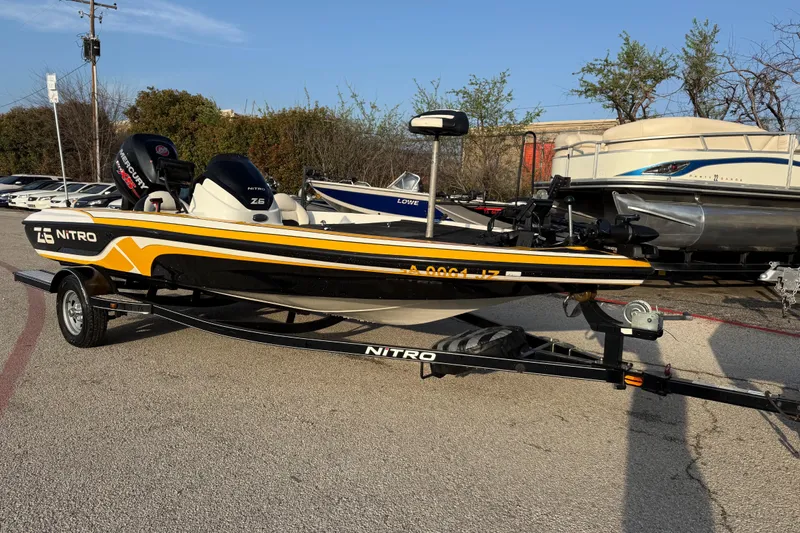 Slide: The Image of 2015 Nitro Z-6 boat on trailer, parked outdoors, featuring sleek design and vibrant colors. - 3