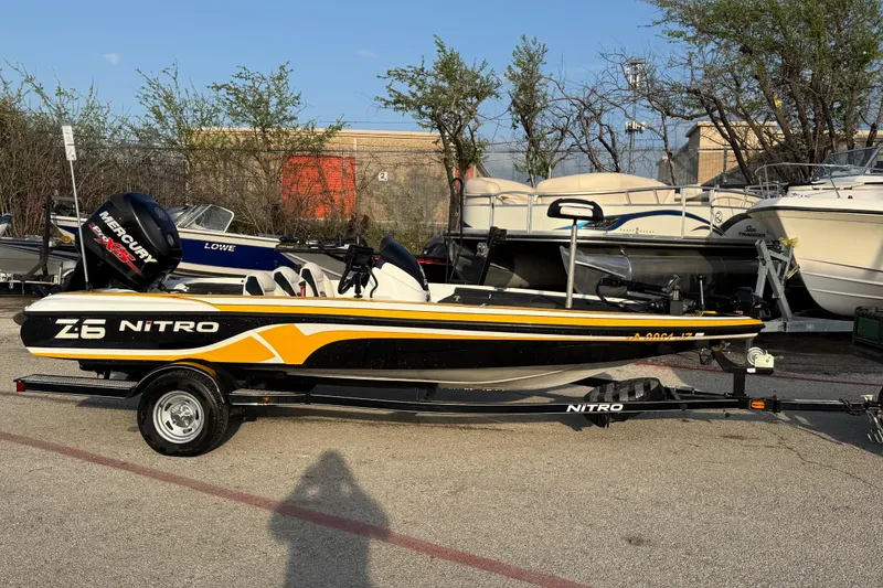 Slide: The Image of 2015 Nitro Z-6 boat with Mercury engine, parked on a trailer in a marina. - 5