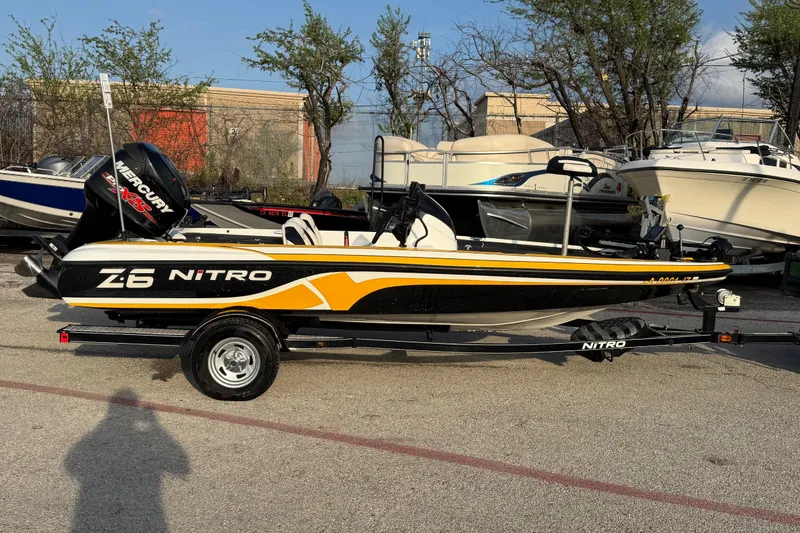 Slide: The Image of 2015 Nitro Z-6 boat with Mercury engine on trailer, parked outdoors. - 6