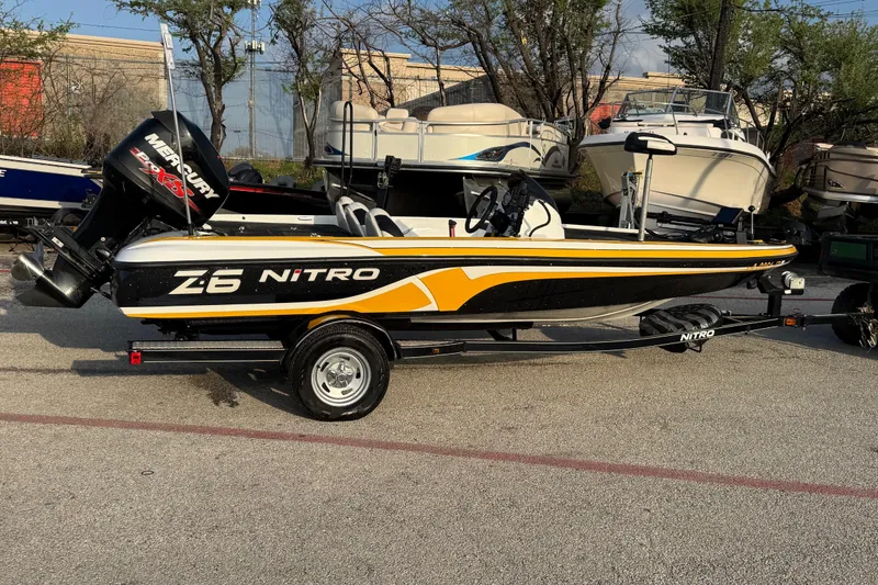 Slide: The Image of 2015 Nitro Z-6 boat with Mercury engine, parked on a trailer in a marina. - 7