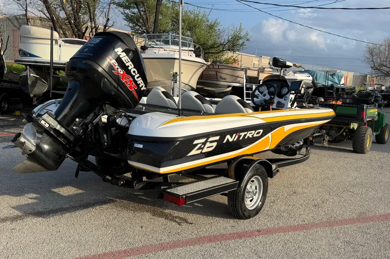 Slide: The Image of 2015 Nitro Z-6 boat with Mercury engine on trailer in parking lot. - 9