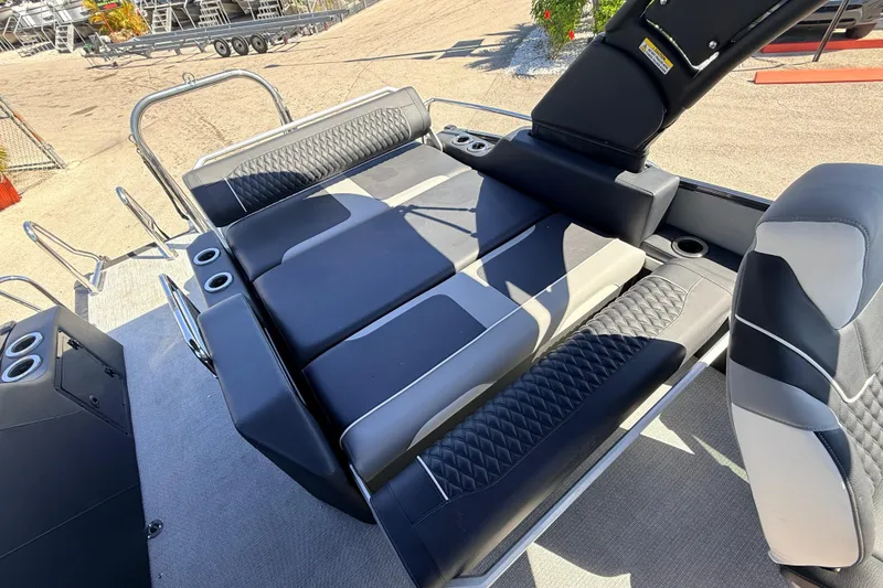 Slide: The Image of 2026 Avalon 2585 Excalibur LTD boat interior with luxurious seating and cup holders. - 20