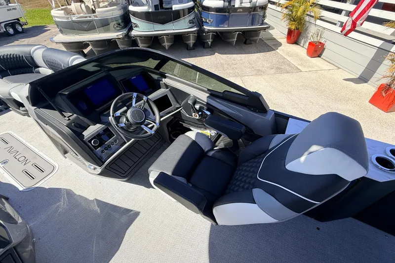 Slide: The Image of 2026 Avalon 2585 Excalibur LTD boat interior with modern dashboard and luxurious seating. - 23