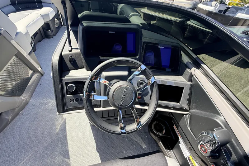 Slide: The Image of 2026 Avalon 2585 Excalibur LTD boat dashboard with modern steering and controls. - 25