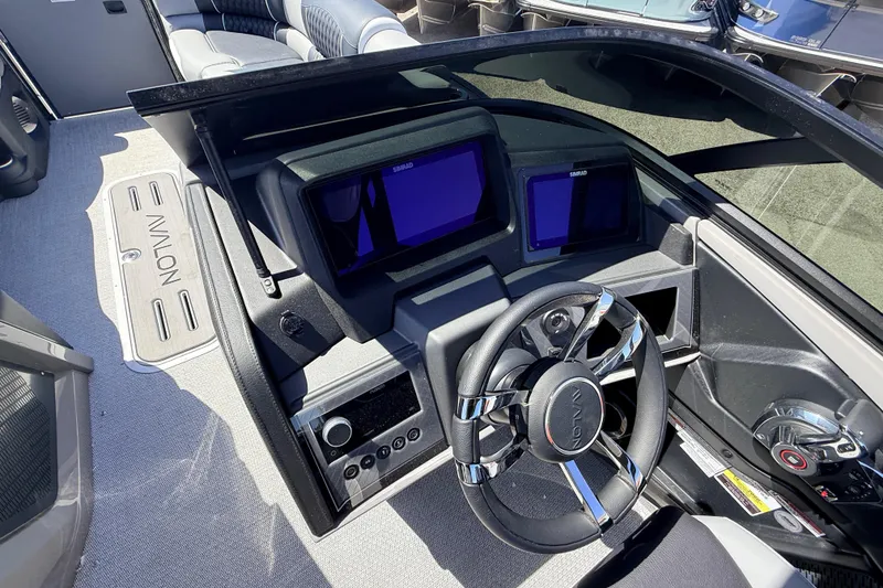 Slide: The Image of 2026 Avalon 2585 Excalibur LTD boat dashboard with modern controls and steering wheel. - 26