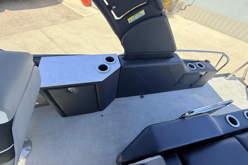 Slide: The Image of 2026 Avalon 2585 Excalibur LTD boat interior with cup holders and seating area. - 28