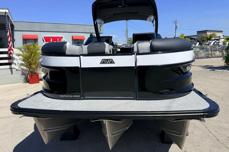 Slide: The Image of 2026 Avalon 2585 Excalibur LTD Tri Toon boat, black and white, parked outdoors. - 4