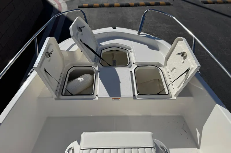 Slide: The Image of 2022 Trophy T18 boat with open storage compartments on deck. - 10