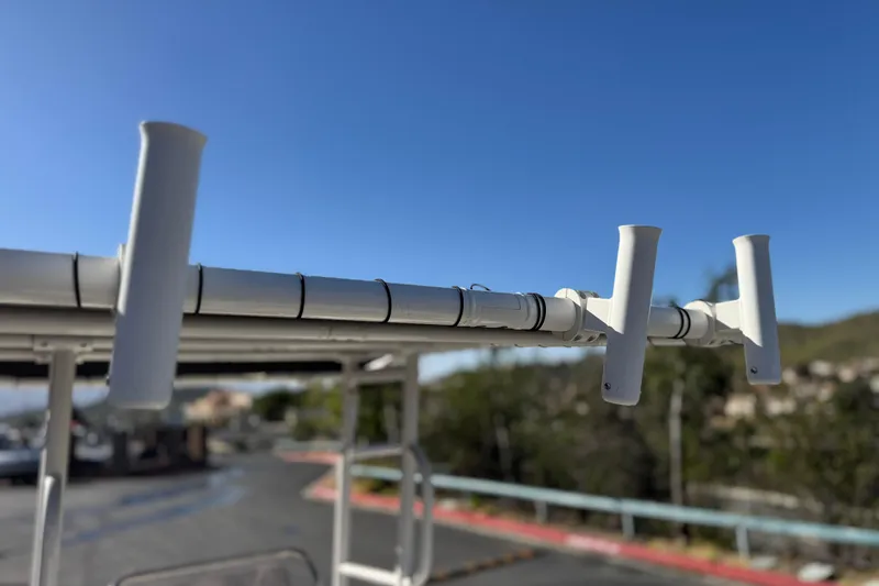 Slide: The Image of Rod holders on a 2022 Trophy T18 boat against a clear blue sky. - 16