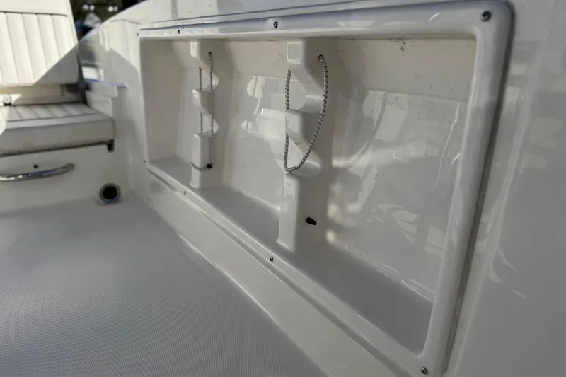 Slide: The Image of Interior view of a 2022 Trophy T18 boat, showcasing storage compartment details. - 17
