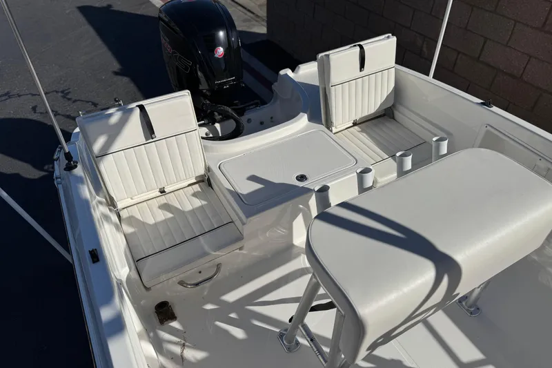 Slide: The Image of 2022 Trophy T18 boat interior with white seating and motor. - 18