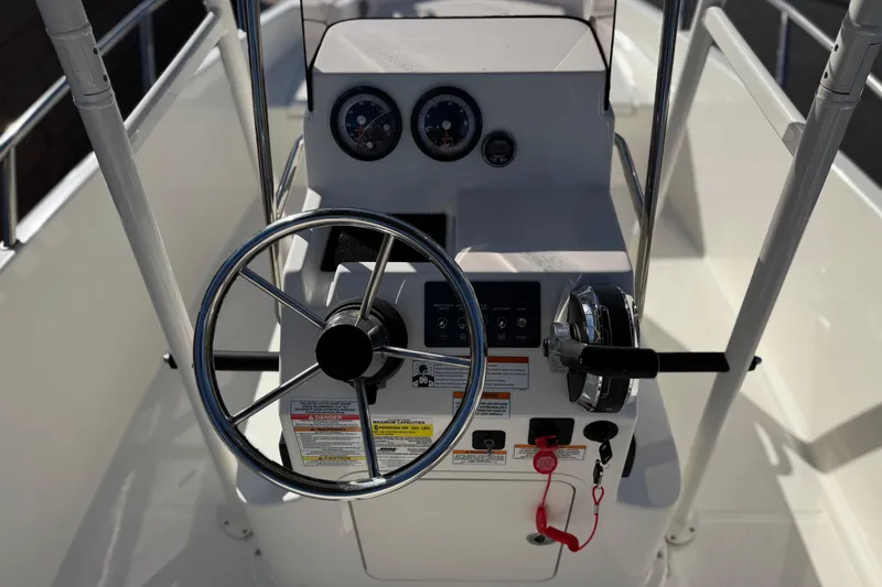 Slide: The Image of 2022 Trophy T18 boat steering console with gauges and controls. - 23