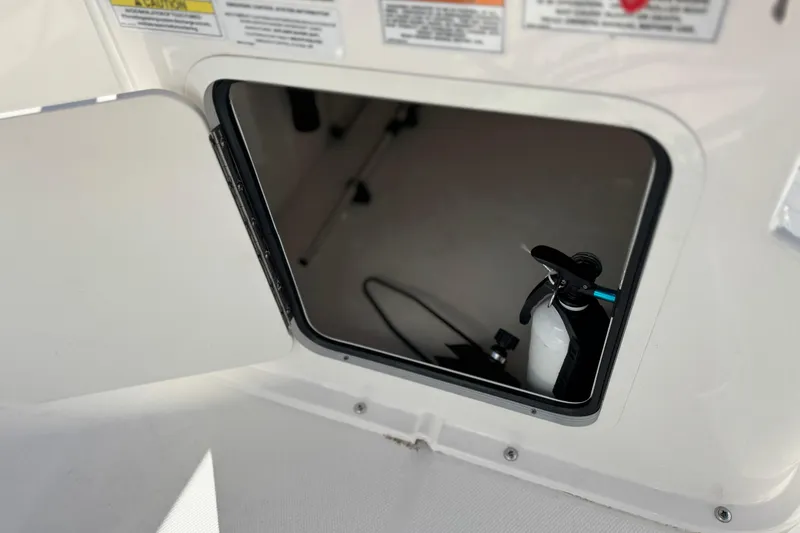 Slide: The Image of Open storage compartment on 2022 Trophy T18 boat, showing interior equipment. - 25