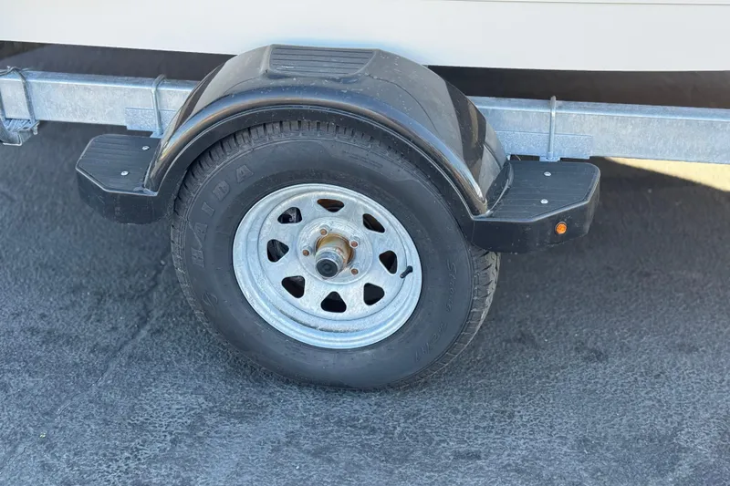 Slide: The Image of Trailer wheel of a 2022 Trophy T18, featuring a sturdy metal fender. - 26