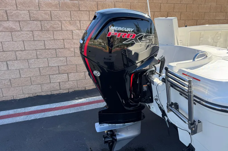 Slide: The Image of 2022 Trophy T18 boat with Mercury Pro XS outboard motor, parked near a brick wall. - 6