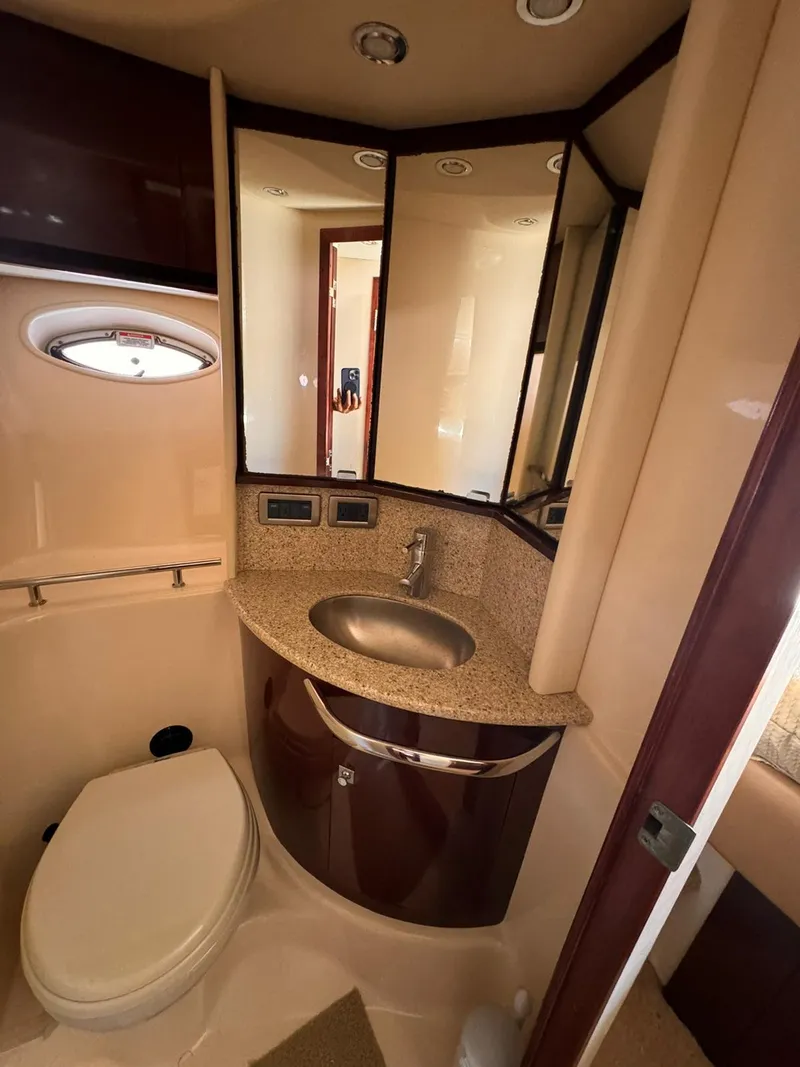Slide: The Image of Luxurious 2008 Sea Ray Sundancer bathroom with sink, toilet, and mirrored cabinets. - 10