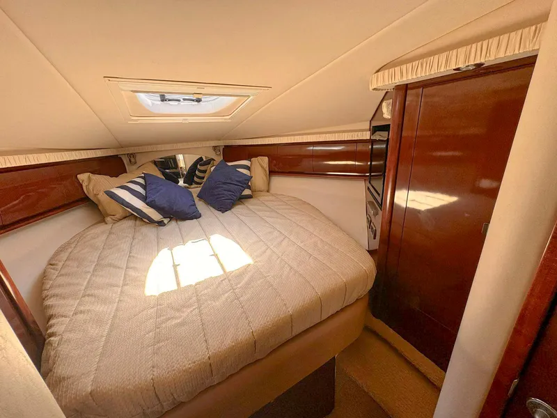 Slide: The Image of Luxurious cabin interior of 2008 Sea Ray Sundancer with cozy bed and elegant wood finish. - 14
