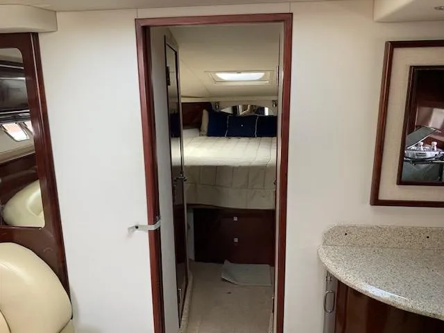Slide: The Image of 2008 Sea Ray Sundancer cabin interior with bed, mirror, and countertop. - 21