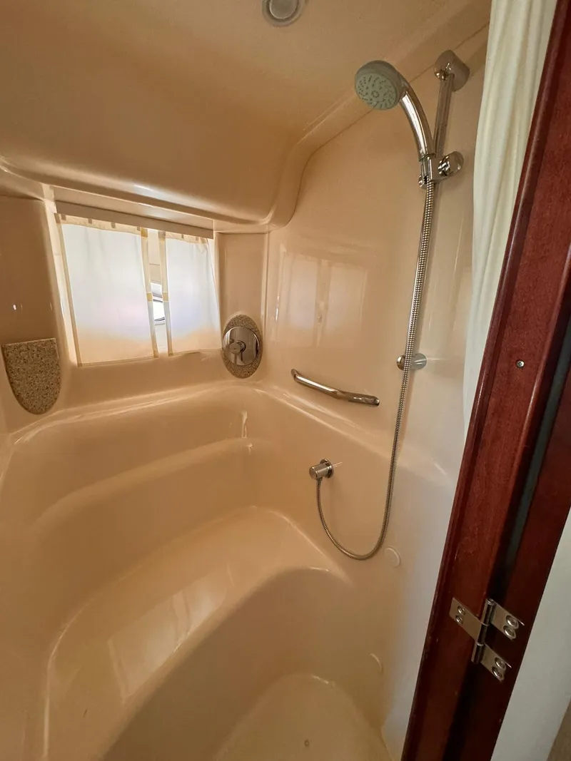 Slide: The Image of Shower area inside a 2008 Sea Ray Sundancer boat, featuring a handheld showerhead. - 23