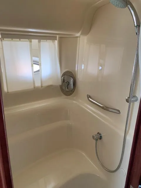 Slide: The Image of Shower area in 2008 Sea Ray Sundancer boat, featuring a handheld showerhead and curtain. - 25
