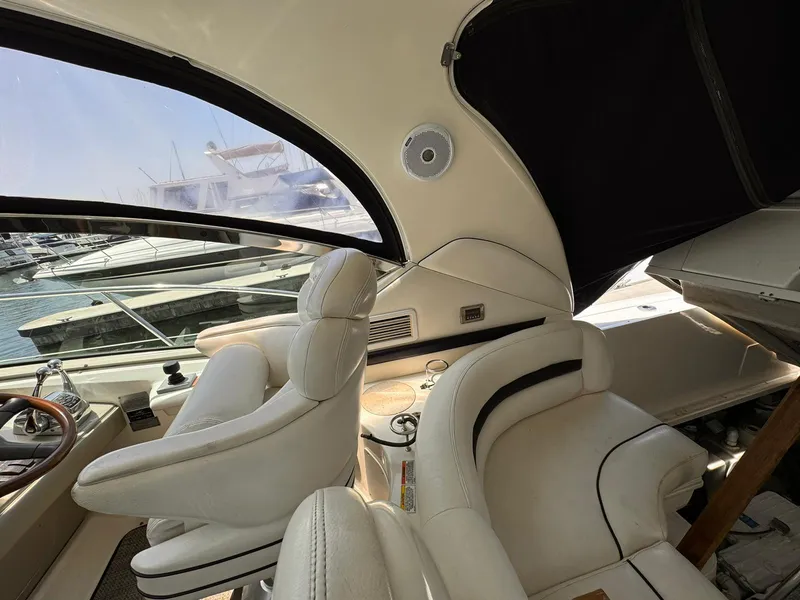 Slide: The Image of Interior of 2008 Sea Ray Sundancer yacht with white leather seating and marina view. - 29