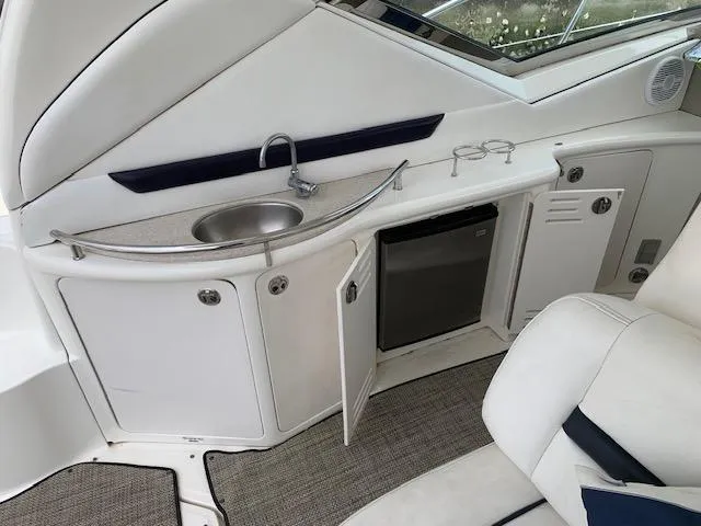 Slide: The Image of 2008 Sea Ray Sundancer yacht interior with kitchenette, sink, and mini fridge. - 39